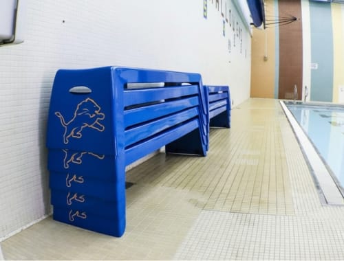 Blue Easy Stack Benches with Lions graphics stacked on a pool deck