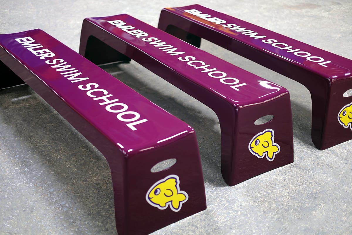 Maroon Easy Stack Benches with Emler Swim School graphics lined up