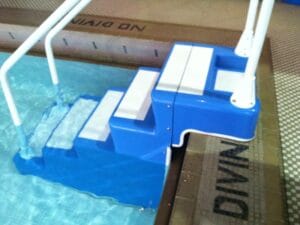 Close-up of blue ADA Easy Stair steps in a pool