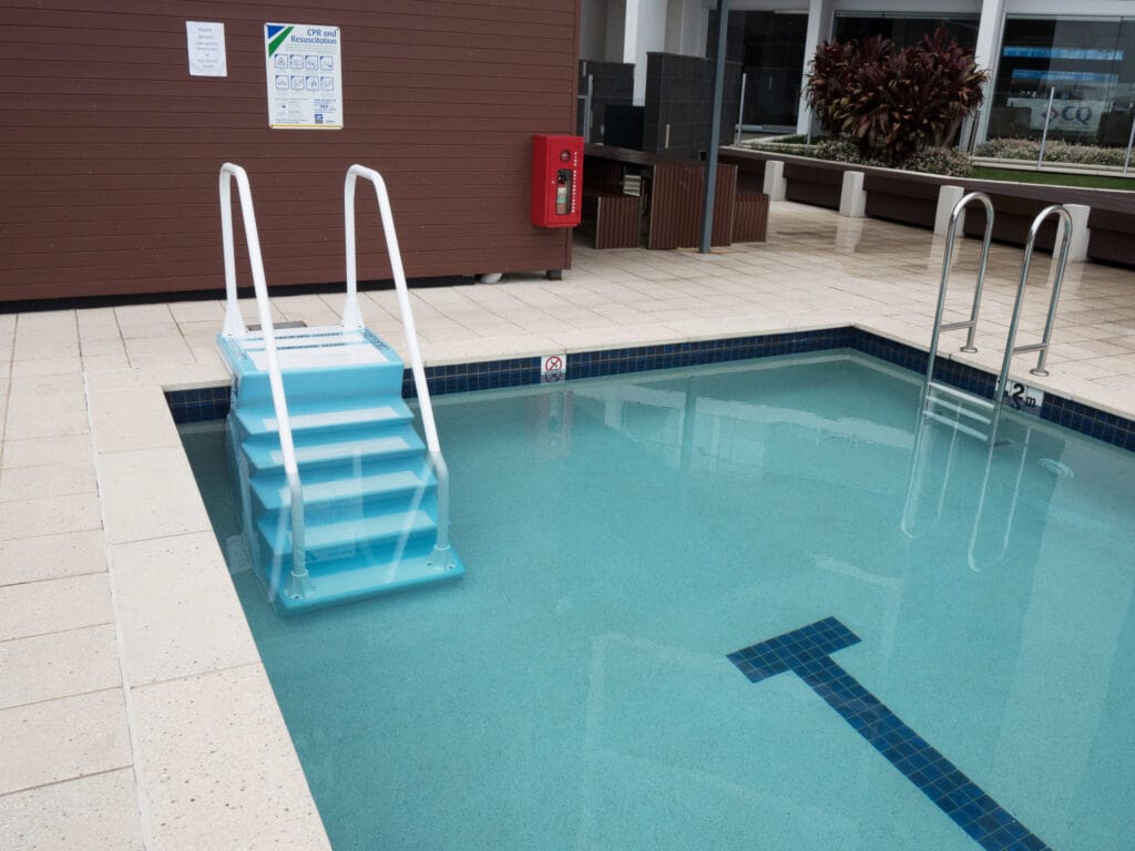 ADA Easy Stair with handrails installed in a swimming pool